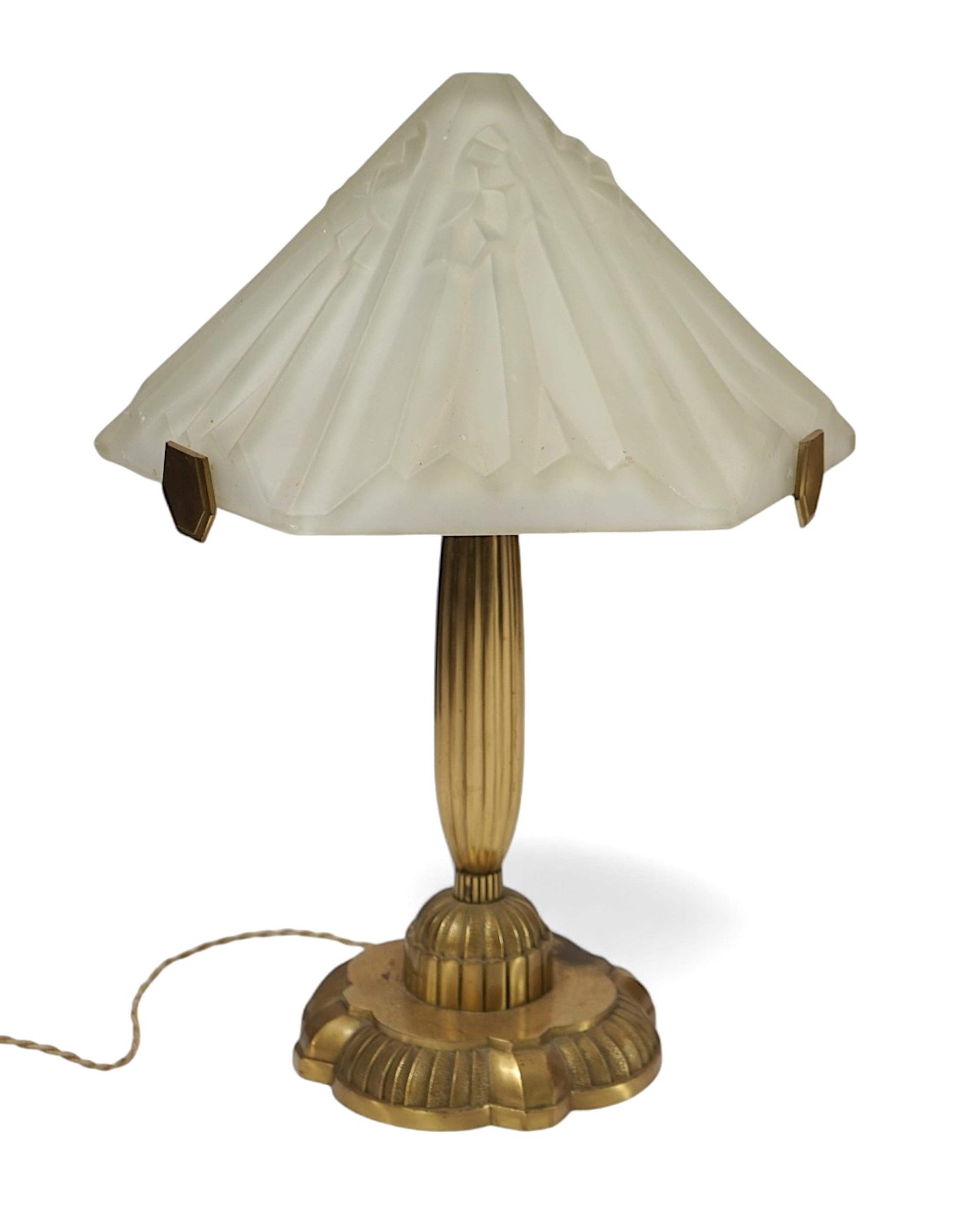 An Art Deco matt gilt brass table lamp with frosted glass shade